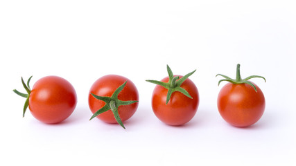 four cherry tomatoes on a white background