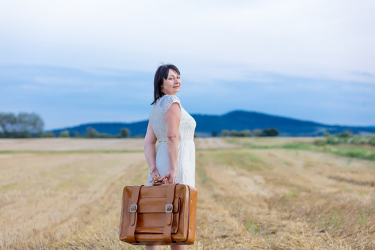 Portrait Of Senior Woman With Travel Suitcase