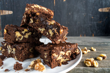 walnut brownies stacked on plate closeup