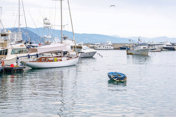 Fototapeta premium Parked boats on water near port of Santa Margherita Ligure in Italy. Tusky day. Cinque Terre