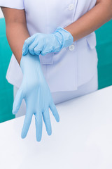 Nurse are wearing sterile gloves to preparation for wound treatment.