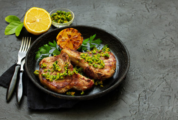 Pork cutlet on a bone with gremolat sauce.
