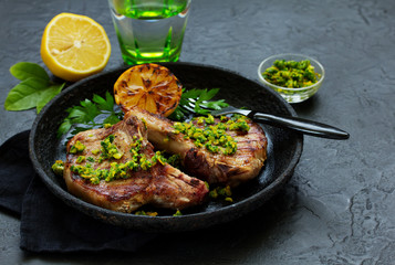 Pork cutlet on a bone with gremolat sauce.