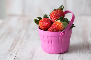 Strawberries in a pink bucket