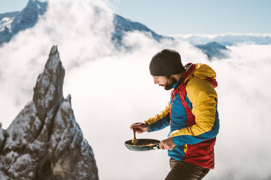 portrait of male mountaineer having breakfast - scrambled eggs -