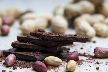 Pile of dark chocolate with peanuts and nutshells