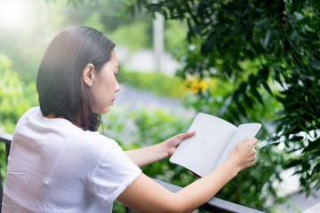 Fototapeta premium Young asian women reading a book enjoys of rest