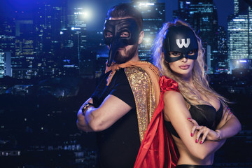 Super hero couple over city