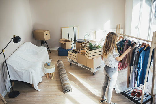 Woman Packing Clothes for Moving In