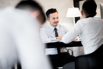 Young Asian entrepreneurs discussing ideas in the office.