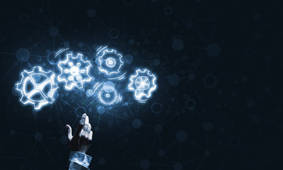Glowing cogwheel mechanism icon on dark background as symbol of teamwork