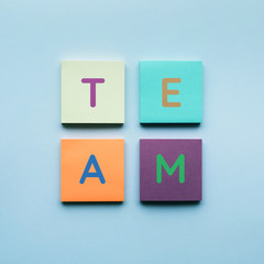 Team text on colorful of notepaper background.