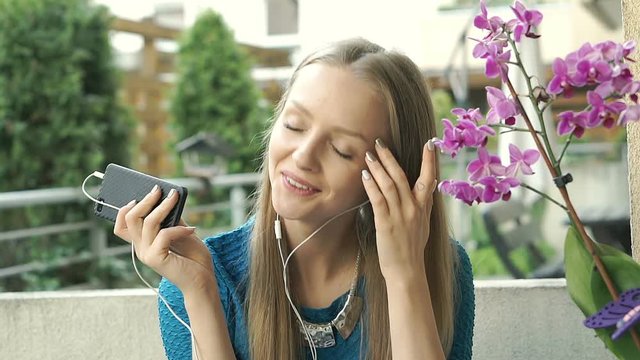 Pretty girl whistle and moving to the rhythm while listening music, steadycam shot
