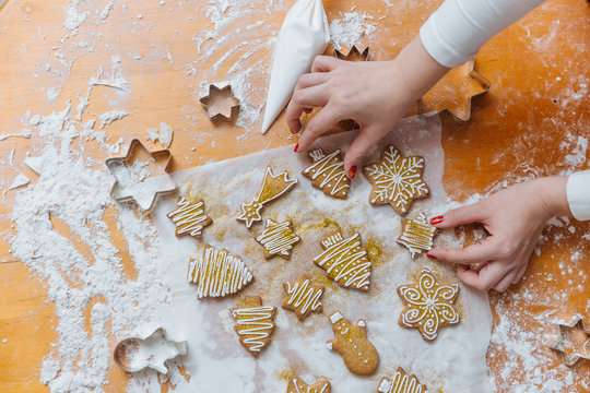 Woman decorating Christmas cookies