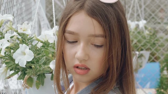 Seductive looking and posing at camera by teen female model. Slowly