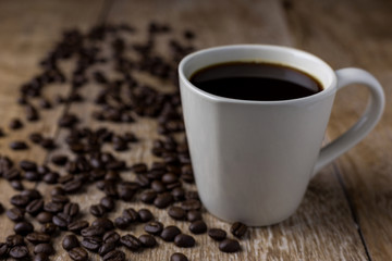 Coffee cup and coffee beans on table