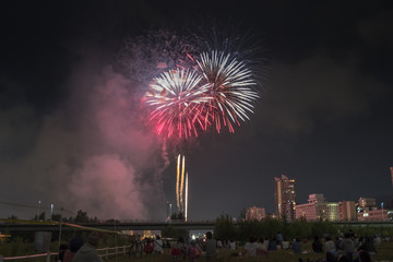 Toyohira River Fireworks, this festival is regarded as Hokkaido most popular fireworks festival over 4000 fireworks light up the night sky over Sapporo, Japan. Image show noise due night shot.