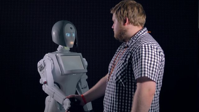 Young man giving handshake to bionic girl.
