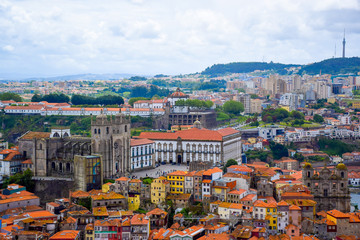 Fototapeta na wymiar View over the old town of Porto, Portugal with the cathedral, the church of St. Lawrence, Ponte de Dom Luis I, Jardim do Morro and colorful buildings from Clerigos tower (Torre dos Clerigos)