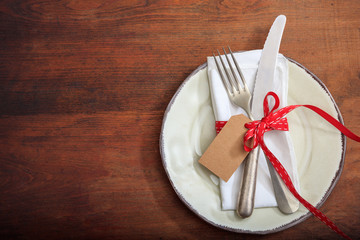 Table setting with tag on wooden background