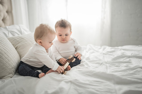 Brothers Playing On A Bed