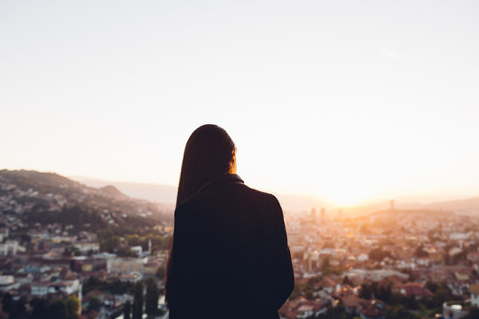 Portrait Of A Woman Looking Over The City At Sunset