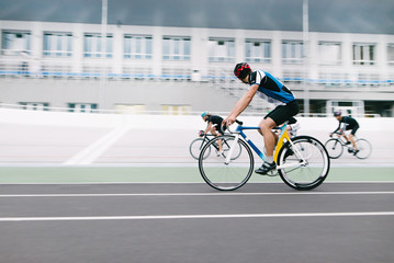 Athletes cyclists ride a bike on an outdoor bike trail. Velodrome. Sports concept. Cycling