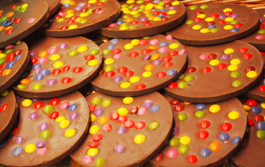 Fototapeta na wymiar Chocolate chip cookies stacked up on a plate with color chocolate