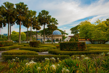 Pavilion and trees with bushes. Miri City Fan Park, Borneo, Sarawak, Malaysia