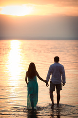 A married couple seeing off the day looking at the evening sunset in nature