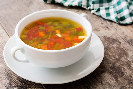 Vegetable soup in bowl on wooden table
