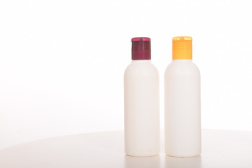Cosmetics in bottles of plastic containers and tubes