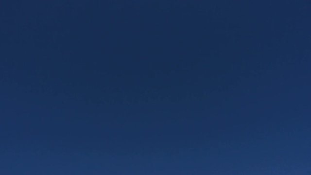 Plane passing by and about to Land. Over blue sky. day.