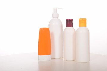Cosmetics in bottles of plastic containers and tubes