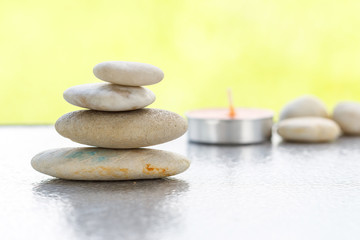 Obraz na płótnie Canvas Stones pyramid symbolizing stability, zen ,Zen spa concept , Zen Massage Stone against green bokeh background