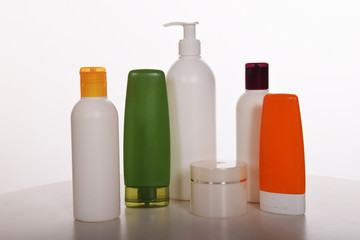 Cosmetics in bottles of plastic containers and tubes