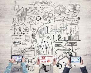 Top view of businesspeople sitting at table and using gadgets