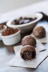 Three Chocolate Truffles with Cocoa Powder and Chocolate Pieces