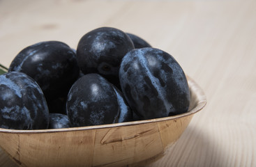 Ripe plums in a bowl