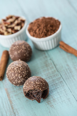 Chocolate Truffles with Cinnamon Sticks and Cocoa Powder and Nuts