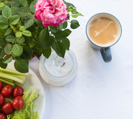 Breakfast, coffee, rose, sugar, vegetables. View from above.Flat lay