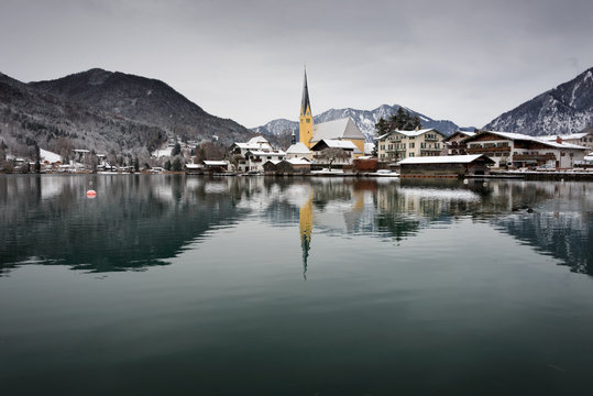 Church at the border of a lake in the snow