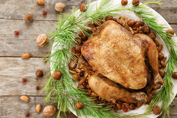 Composition with whole roasted turkey, coniferous branches and nuts