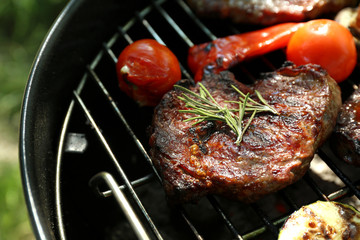 Tasty steak and vegetables on barbecue grill