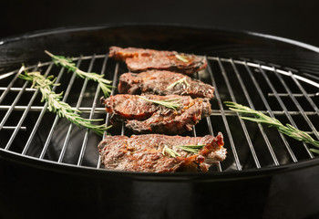 Tasty steaks with rosemary on barbecue grill