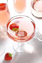 Glass of delicious strawberry wine on white background