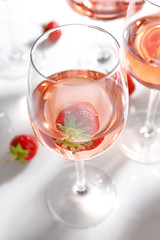 Glass of delicious strawberry wine on white background
