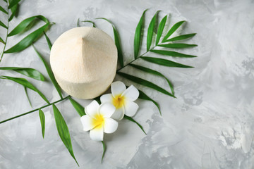 Composition with fresh coconut on gray textured background