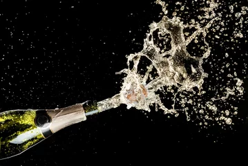 Gardinen Celebration and holiday theme. Champagne splashes on black background © Nikolay N. Antonov