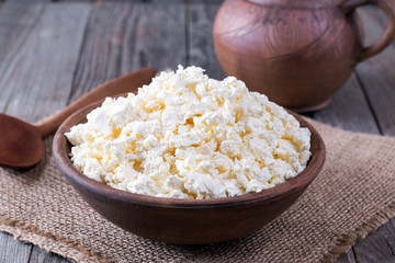 Fresh cottage cheese in a wooden bowl
